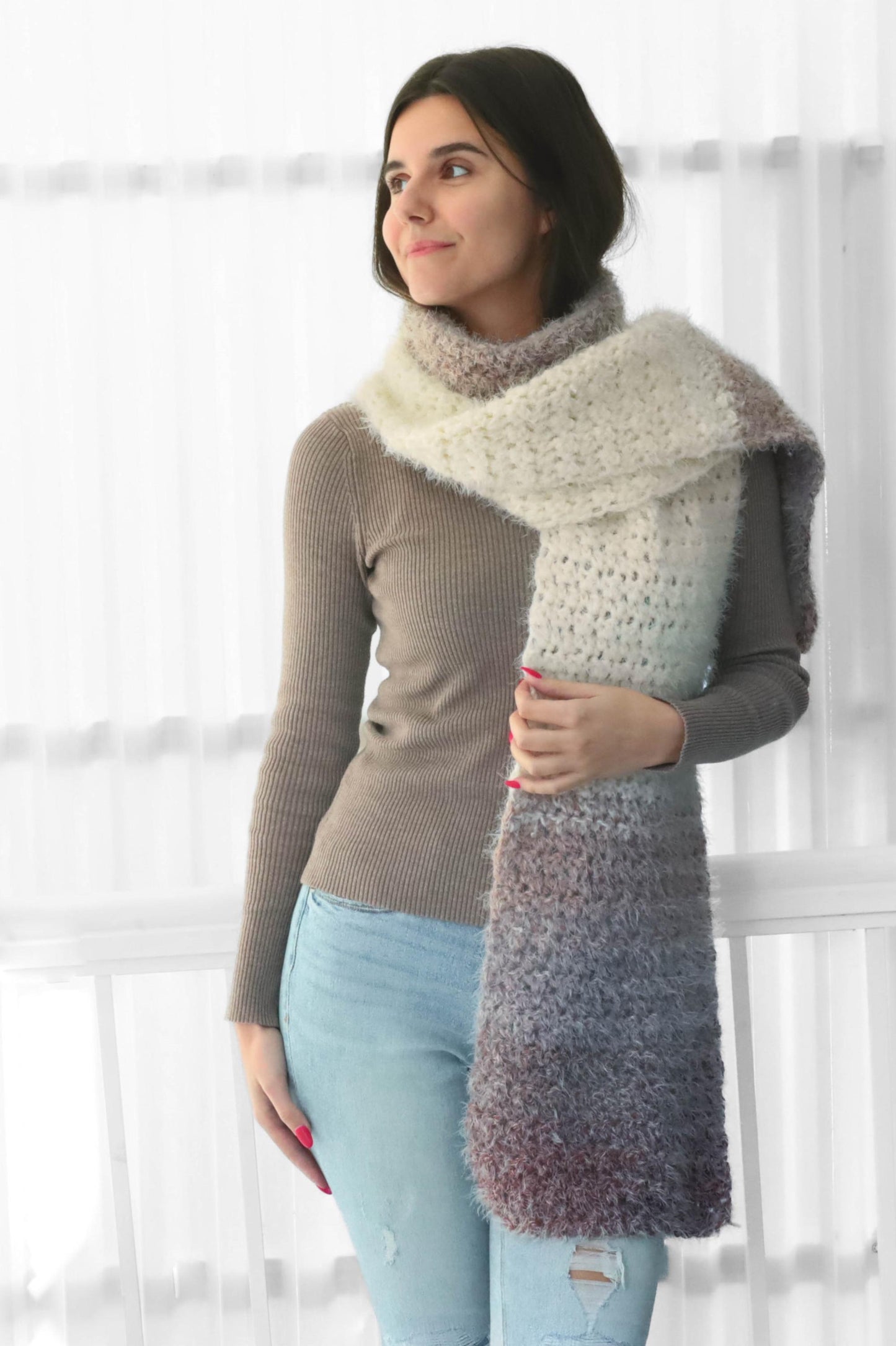 May include: A long, fluffy scarf with a gradient of white, gray, and purple. The scarf is made of a soft, fuzzy yarn and is perfect for keeping warm in the winter.