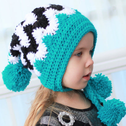 May include: A turquoise and black and white crocheted hat with pom poms on the ends of the ties. The hat has a pointed crown and ear flaps.