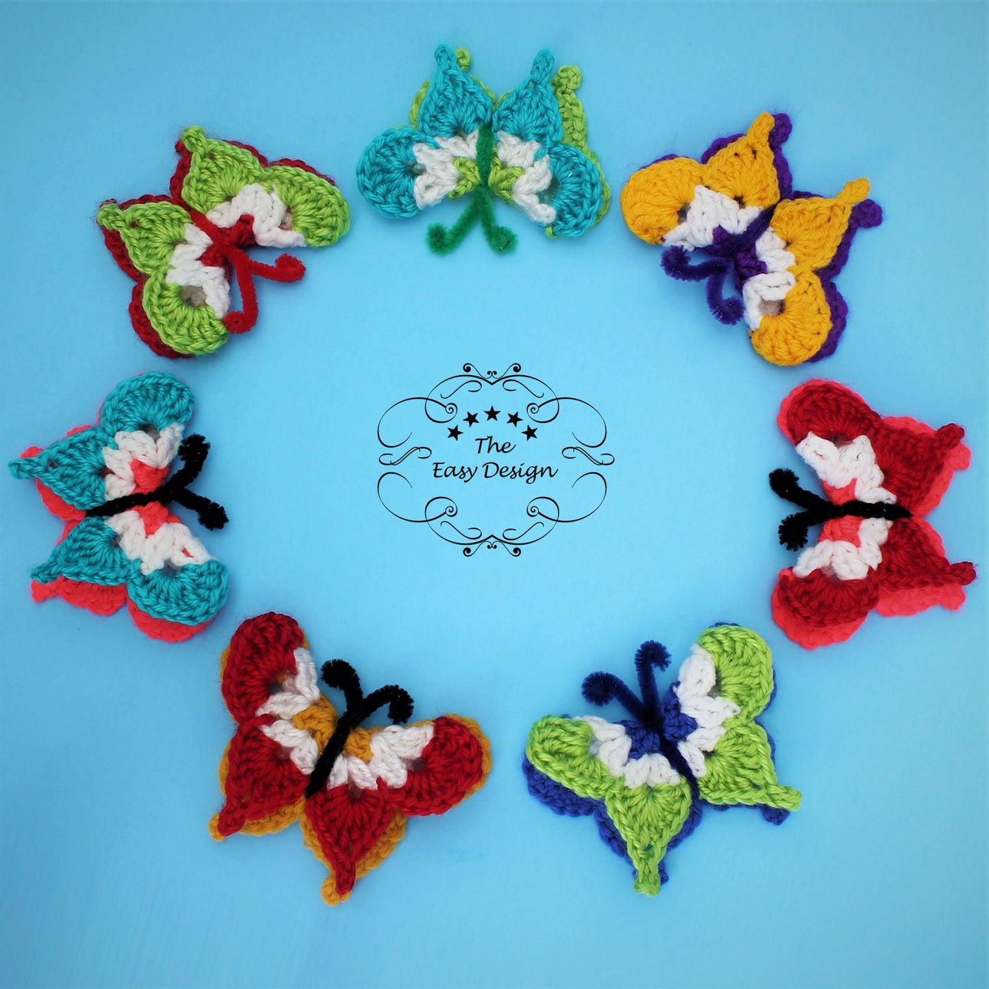 May include: Seven crocheted butterflies in different colors, including red, yellow, green, blue, and white, arranged in a circle on a light blue background. The text "The Easy Design" is in the center of the circle.