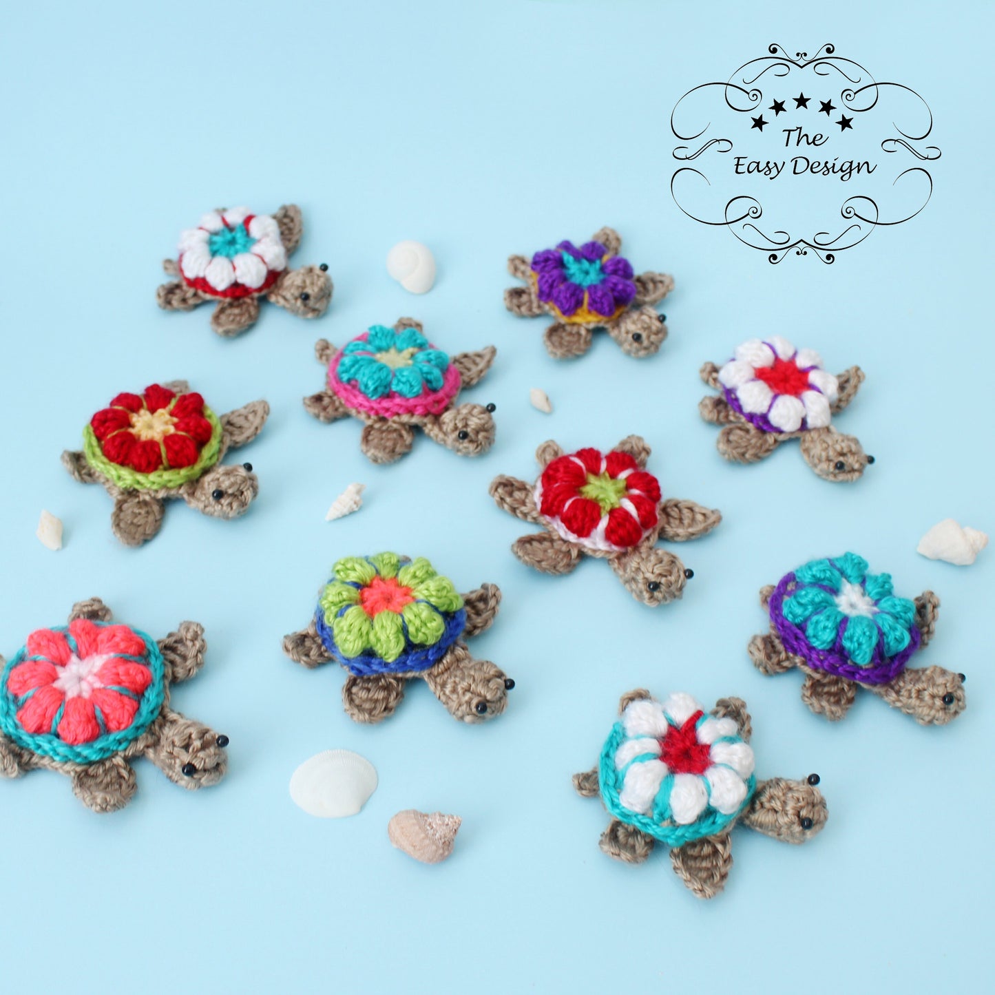 May include: Ten crocheted sea turtles with colorful flower designs on their shells. The turtles are arranged on a light blue background.