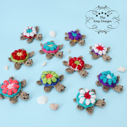 May include: Ten crocheted sea turtles with colorful flower designs on their shells. The turtles are arranged on a light blue background.