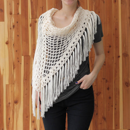 May include: A white crochet shawl with a fringe border. The shawl is draped over a person's shoulders and is made with a delicate openwork pattern.
