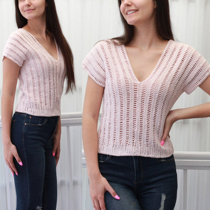 May include: A pink crochet top with a V-neck and short sleeves. The top is made with a delicate open stitch pattern.