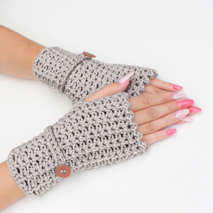 May include: A pair of gray fingerless gloves with a button detail. The gloves are crocheted and have a scalloped edge.