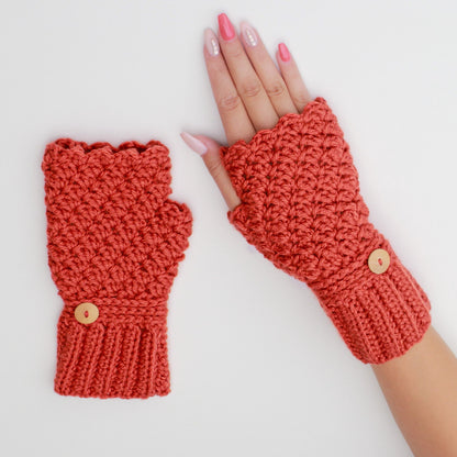 May include: A pair of crocheted fingerless gloves with a scalloped edge and a wooden button. The gloves are a warm terracotta color.
