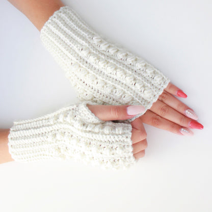 May include: A pair of white crocheted fingerless gloves with a textured pattern. The gloves are shown on a white background.