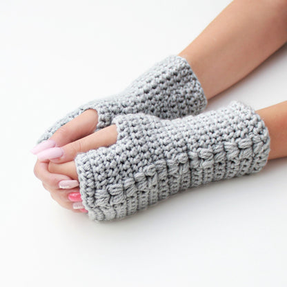 May include: A pair of gray fingerless gloves with a textured knit pattern. The gloves are made of a soft, warm yarn and are perfect for keeping your hands warm in the winter.