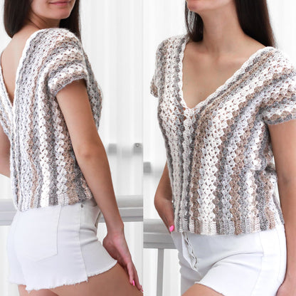 May include: A white crochet top with a v-neck and short sleeves. The top has a striped pattern in shades of white, brown, and gray.
