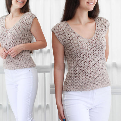 May include: A beige crochet top with a v-neck and short sleeves. The top is made with a delicate open stitch pattern.