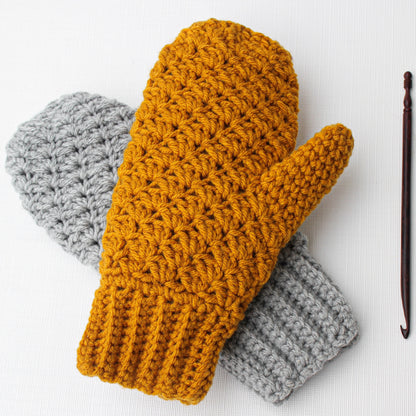 May include: A pair of crocheted mittens, one in mustard yellow and one in gray. The mittens are made with a textured stitch and have a ribbed cuff.