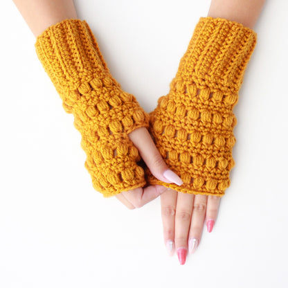 May include: A pair of yellow crocheted fingerless gloves with a textured design.