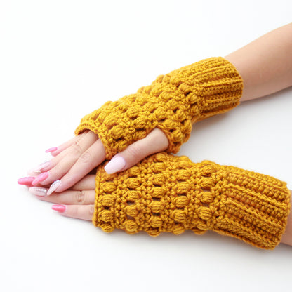 May include: A pair of yellow crocheted fingerless gloves with a textured design.