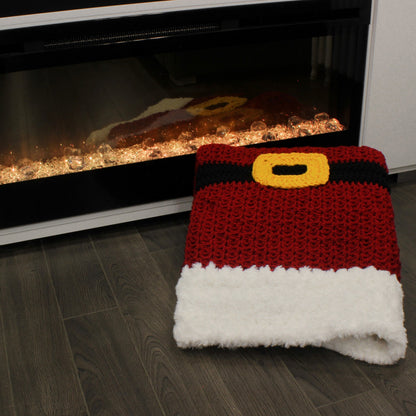 May include: A crocheted Santa Claus hat with a red body, black belt, and yellow buckle. The hat is white and fluffy.