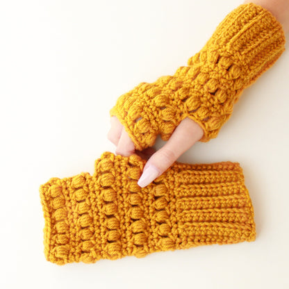 May include: A pair of yellow crocheted fingerless gloves. The gloves have a textured, puffy design.