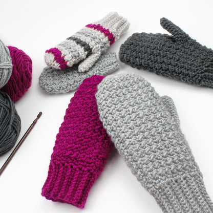 May include: A set of four crocheted mittens in various colors, including gray, pink, and black. The mittens are made with a textured stitch and have a simple, classic design.