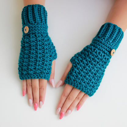 May include: A pair of teal blue fingerless gloves with wooden buttons. The gloves are crocheted and have a textured pattern.