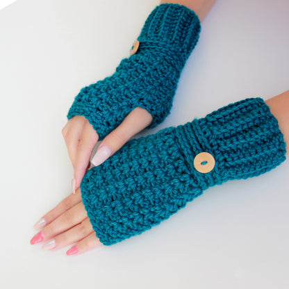 May include: A pair of teal blue crocheted fingerless gloves with wooden buttons. The gloves are made with a textured stitch and are shown on a white background.