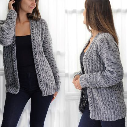 May include: A gray crocheted cardigan with a V-neck and long sleeves. The cardigan has a textured stitch pattern and a loose fit.