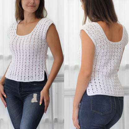 May include: White crochet top with a scoop neck and short sleeves. The top has a loose fit and a slightly cropped length. The model is wearing the top with blue jeans.