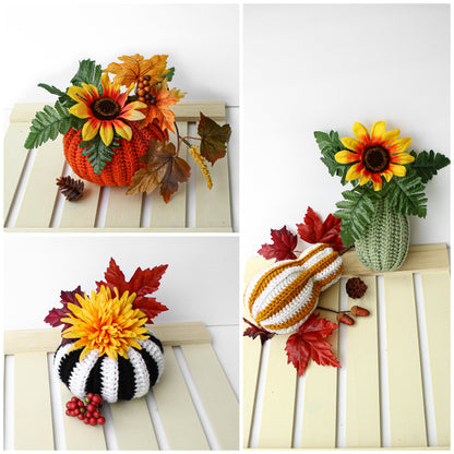 May include: Three crocheted pumpkins with fall-themed decorations. The pumpkins are orange, white and black striped, and green. The decorations include sunflowers, fall leaves, and berries.