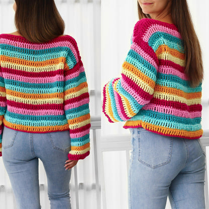 May include: A rainbow striped crochet sweater with long sleeves. The sweater is a cropped style and is made with a variety of colors, including pink, yellow, orange, blue, and green.