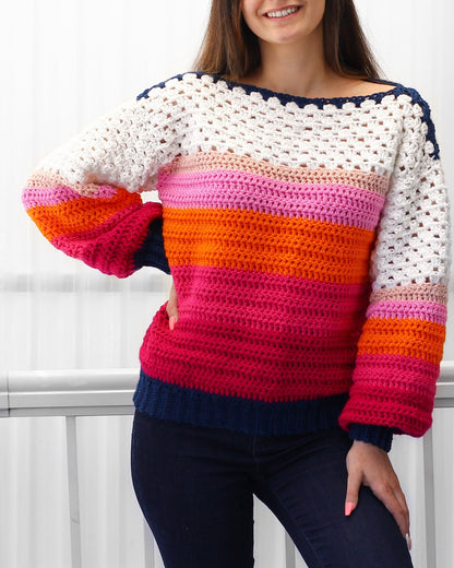 May include: A colorful striped crochet sweater with a white crocheted neckline and long sleeves. The sweater is made with a variety of colors, including pink, orange, and blue.