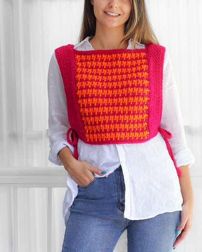 May include: A pink and orange crocheted vest with a geometric pattern. The vest has a square neckline and ties at the sides.