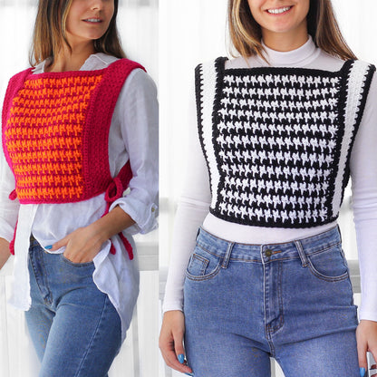 May include: Two women wearing crocheted tops. One top is pink and orange, the other is black and white. Both tops are worn over white shirts and blue jeans.