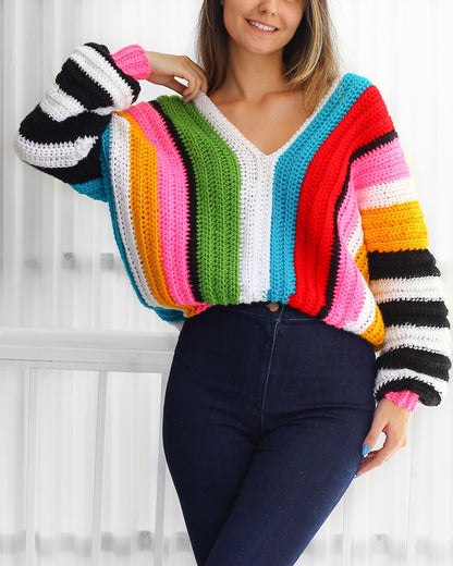 May include: A colorful striped crochet sweater with a V-neck and long sleeves. The sweater is made with a variety of colors, including red, orange, yellow, green, blue, and purple.
