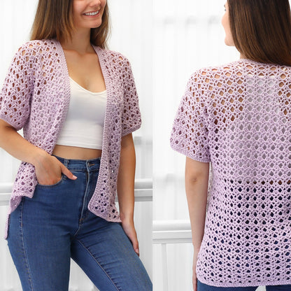 May include: A light purple crochet cardigan with a lacy open stitch pattern. The cardigan has short sleeves and a relaxed fit.