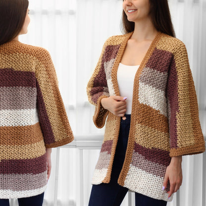 May include: A handmade, open-front crochet cardigan in a color block design. The cardigan features horizontal stripes in shades of tan, brown, white, and mauve. The sleeves are three-quarter length. The garment is shown on a person.