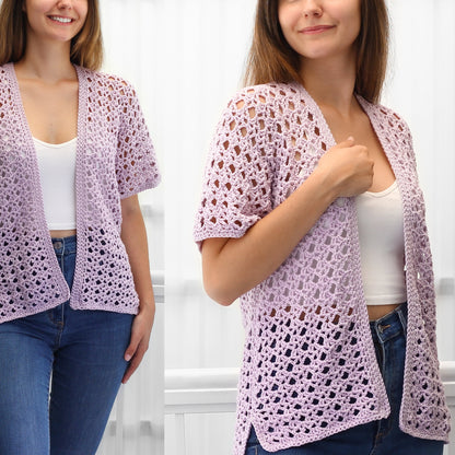 May include: A light purple crochet cardigan with a V-neck and short sleeves. The cardigan is open in the front and has a delicate, lacy pattern.