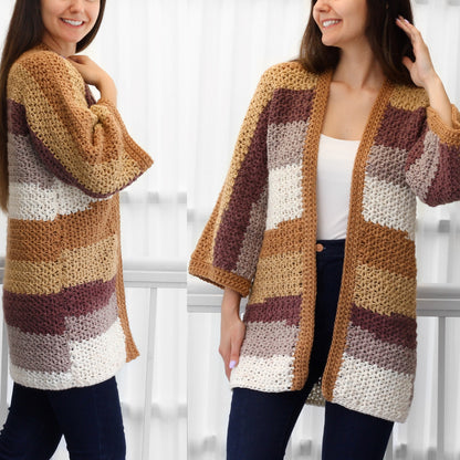 May include: A handmade, open-front crochet cardigan in a patchwork design. The color palette includes shades of tan, brown, cream, and mauve. The cardigan features wide, three-quarter length sleeves and a textured stitch pattern, perfect for layering.