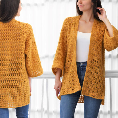 May include: A mustard yellow crochet cardigan with a loose fit and long sleeves. The cardigan is open in the front and has a delicate stitch pattern.