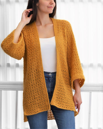 May include: A mustard yellow crochet cardigan with a loose fit and 3/4 sleeves.