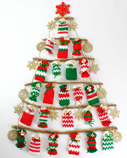 May include: A Christmas tree made of twigs with crocheted candy cane ornaments hanging from each branch. The ornaments are red, white, and green and have a snowflake design. There are wooden snowflakes hanging from the branches as well.