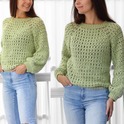 May include: A light green crochet sweater with a loose fit and a slightly puffed sleeve. The sweater has a simple stitch pattern and a round neckline.