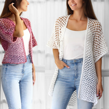 May include: Two women wearing crocheted cardigans. One cardigan is pink and the other is white. Both women are wearing blue jeans.