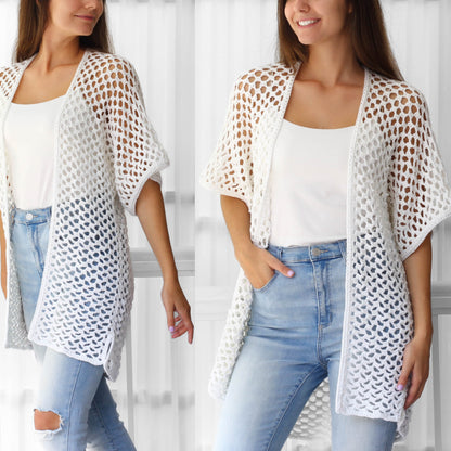 May include: White crochet cardigan with a loose fit and open front. The cardigan has a delicate, open-stitch pattern and short sleeves.