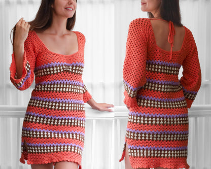 May include: A crocheted dress with a striped pattern in shades of orange, brown, purple, and white. The dress has a scoop neckline and long sleeves with bell bottoms. The dress has a tie at the back of the neck.
