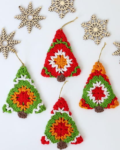 May include: Five crocheted Christmas tree ornaments in red, green, white, orange, and brown. The ornaments are hanging from gold string.
