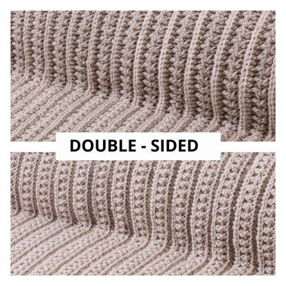 May include: A beige crochet blanket featuring a textured ribbed pattern with vertical lines. The image displays two sections of the fabric with the text DOUBLE-SIDED printed in black on a white rectangular background centered between the two views.