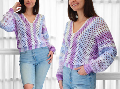 May include: A purple, white, and blue striped crochet sweater with a v-neck.