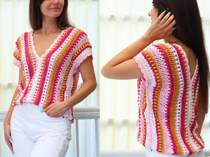 May include: A colorful, short-sleeved crochet top with a V-neck. The top features vertical stripes in shades of pink, white, yellow, and gold. The edges of the sleeves and neckline have a scalloped trim. The top is paired with white pants.
